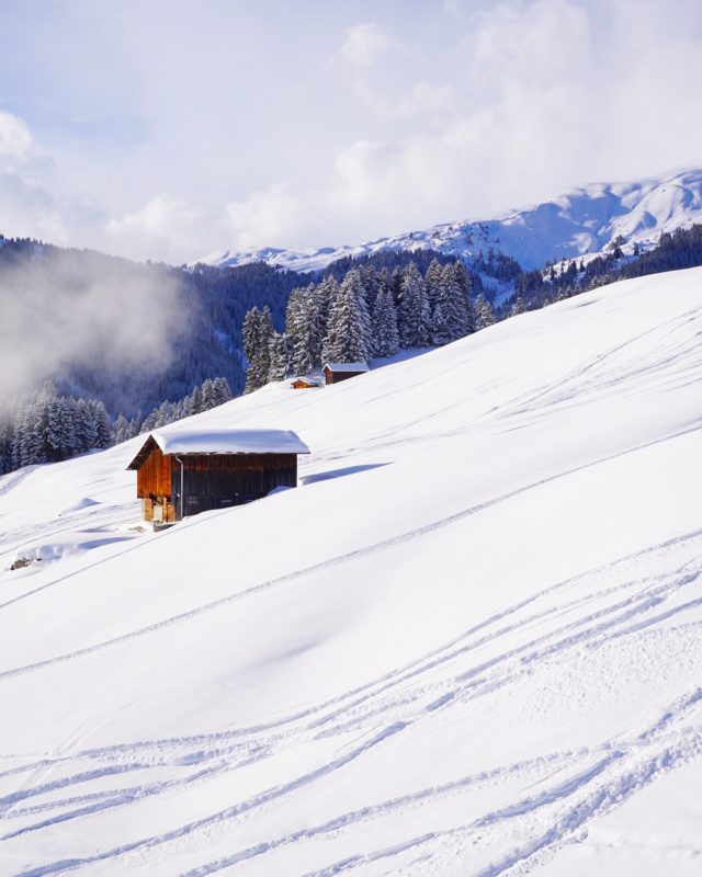 Positive Travel Best Sustainable Ski Resorts in Switzerland Laax mountain slop covered with snow